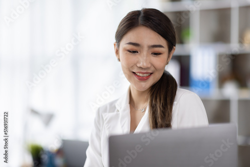 Business of Asian woman or accountant working on calculator to calculate business data, accounting document, and laptop computer at home office, business finances and calculate concept