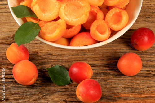 Pitted Apricots with Pits on a White Dish