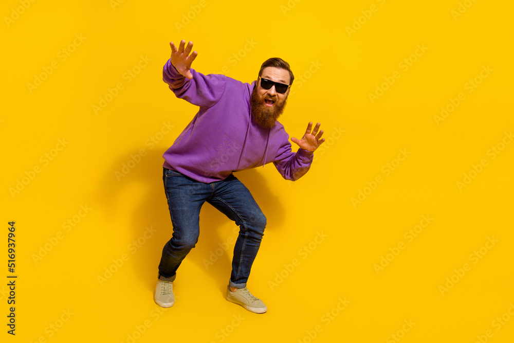 Full size photo of charismatic dancing ginger man have fun in nightclub isolated on yellow color background Full size photo of charismatic dancing ginger man have fun in nightclub isolated on yellow color background