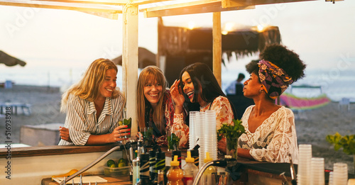 Photography Happy girls having fun drinking cocktails at bar on the beach - Summer and party
