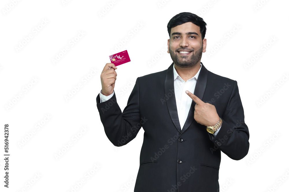 Young smiling man in pointing on credit card. Young smiling man in pointing on credit card.