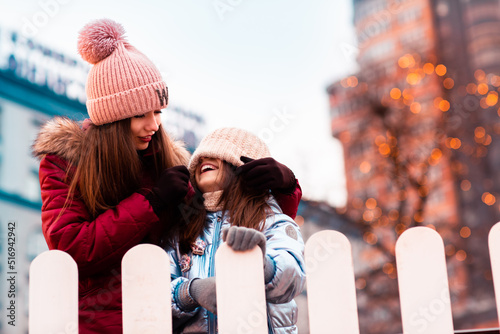 Obraz na płótnie Two sisters, girlfriends, walk around the New Year's location in the city