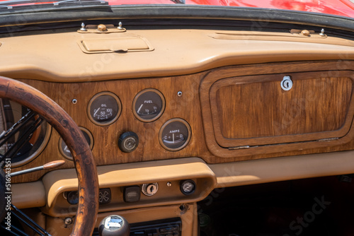 Vintage car interior - Wooden steering wheel and dashboard