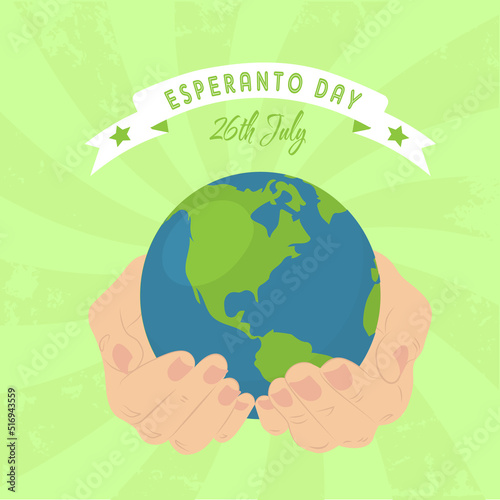 Esperanto Day 26 July postcard. Hands are holding Earth with inscription Esperanto Day on ribbons with green stars. Green vintage stripes on the background. photo