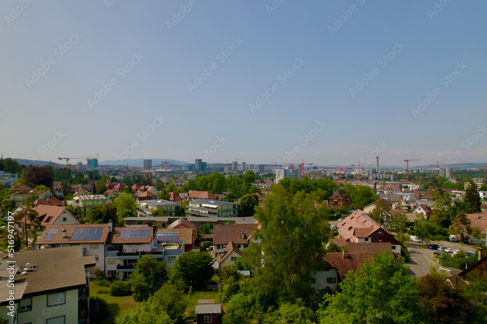 Aerial view over City of Zürich seen from district Schwamendingen on a sunny hot summer day. Photo taken June 21st, 2022, Zurich, Switzerland.