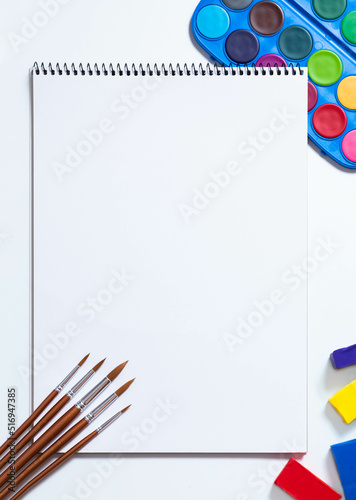 Painting tools on white background.  Marker and notebook on white background, brushes, watercolor.