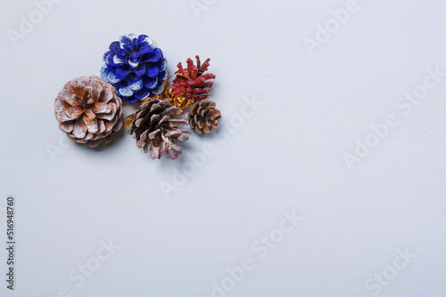 Eco friendly Christmas, New Year decorations, multicolored painted natural pine, fir cones, no plastic concept. Copy space.