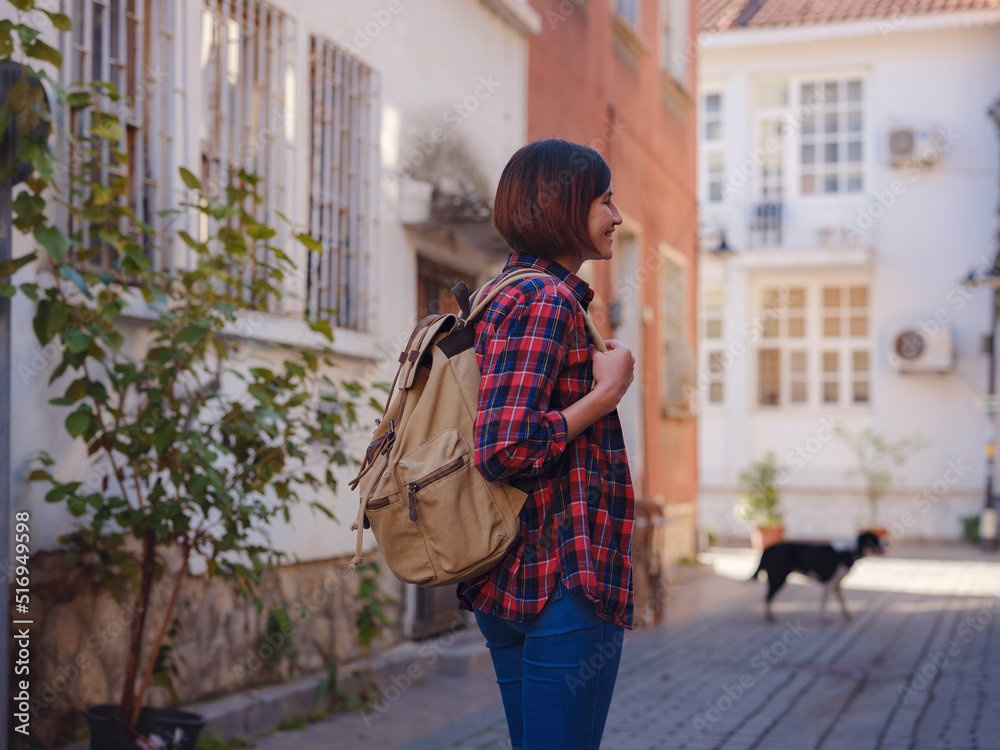 travel to Turkey, old town Antalya Kaleci Famous tourist destination . Happy asian female tourist traveller with backpack walks in old city.