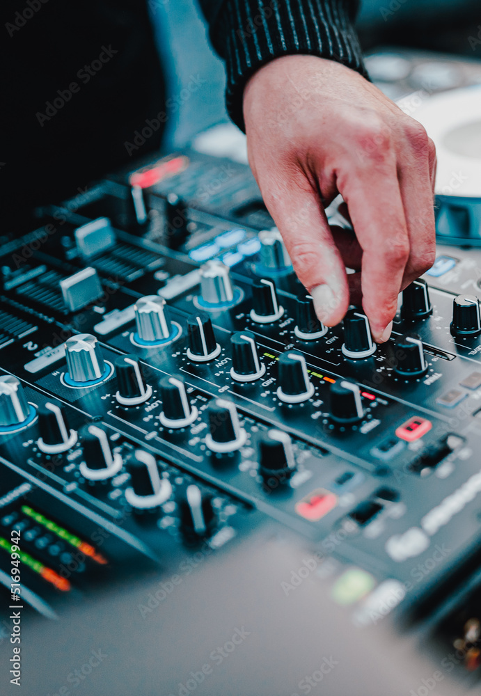 DJ Hands creating and regulating music on dj console mixer in concert outdoor DJ Hands creating and regulating music on dj console mixer in concert outdoor