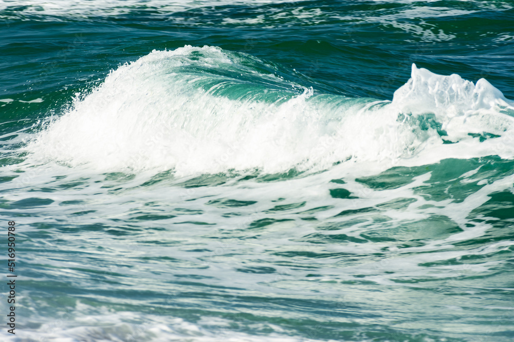 abstract sea background. green wave close up. blurry water in evening light abstract sea background. green wave close up. blurry water in evening light