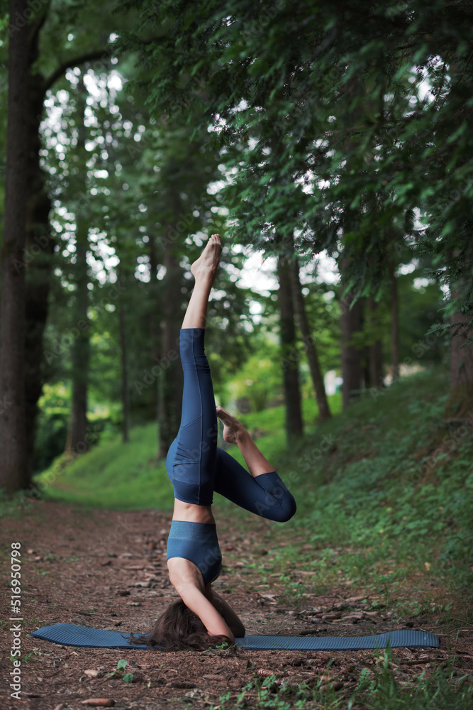 Fit woman practicing yoga in nature