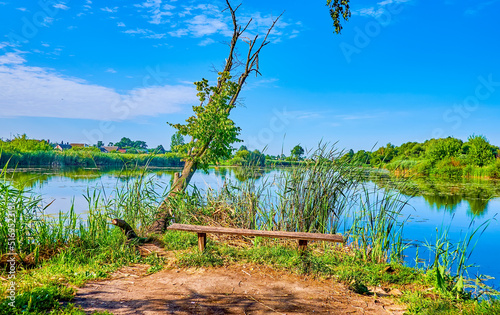 Romantic banch on the bank of Kodnyanka River, Old Solotvyn, Ukraine photo