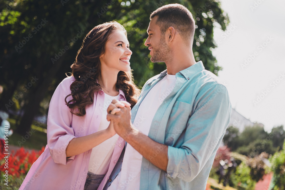 Photo of shiny dreamy boyfriend girlfriend wear casual outfits walking holding arms enjoying sunny weather outdoors garden Photo of shiny dreamy boyfriend girlfriend wear casual outfits walking holding arms enjoying sunny weather outdoors garden