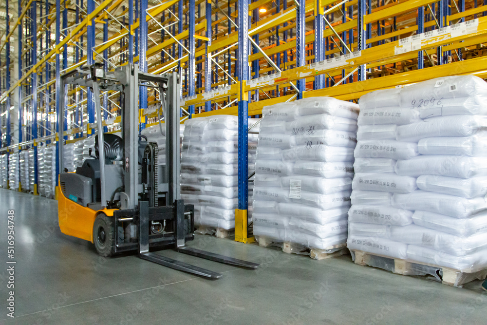 Interior of a modern warehouse with forklifts. Pallet stacker truck equipment at warehouse. Forklift loader Interior of a modern warehouse with forklifts. Pallet stacker truck equipment at warehouse. Forklift loader
