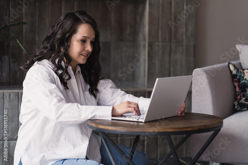 Girl working on laptop from home or student studying from home or freelancer. Online work, early in the morning desk work, home office. High quality photo