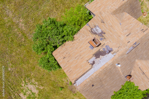 High winds and strong storms have damaged roof shingles from an aerial point of top view