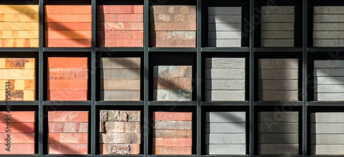Stacks of various bricks on shelves. Examples of building materials