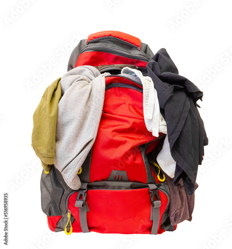 Badly folded clothes. Clothes sticking out of a backpack. Overflowing tourist backpack on a white background.