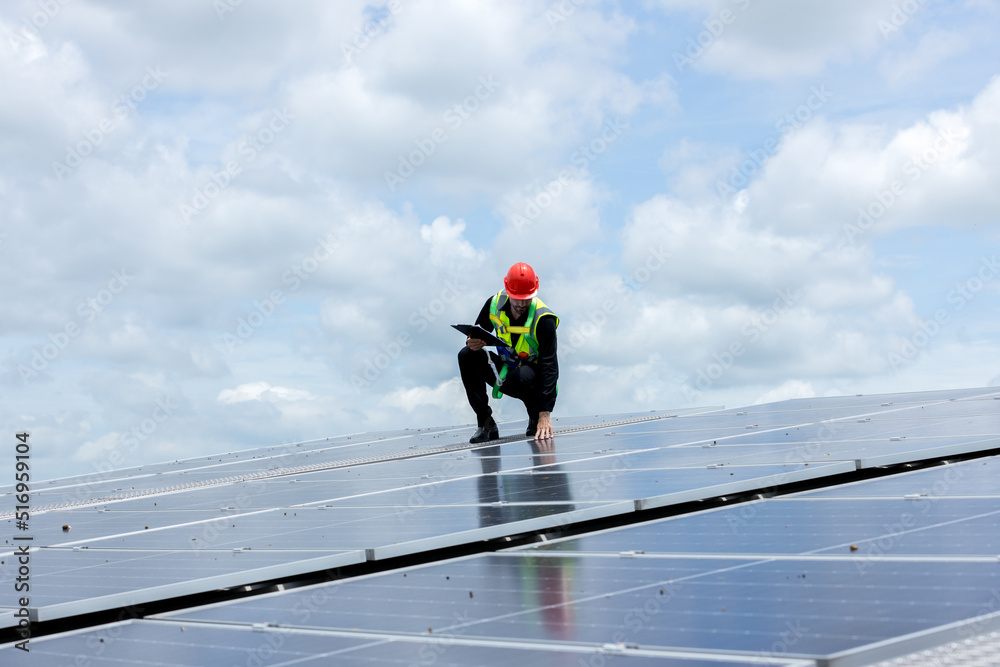 Engineer working setup Solar panel at the roof top. Engineer or worker work on solar panels or solar cells on the roof of business building Engineer working setup Solar panel at the roof top. Engineer or worker work on solar panels or solar cells on the roof of business building