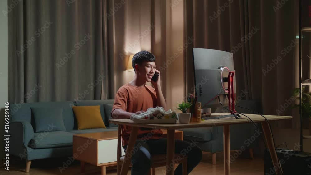 Asian Boyfootwear Designer Talking On Smartphone While Working On A Desktop Computer At Home
Asian Boyfootwear Designer Talking On Smartphone While Working On A Desktop Computer At Home