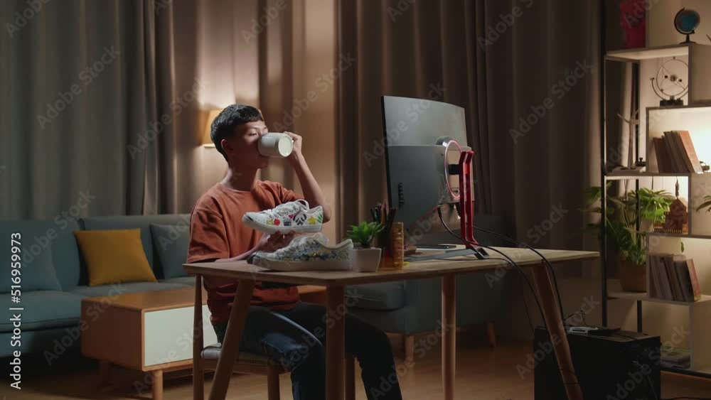 Asian Boy Footwear Designer Drinking Coffee While Working On A Desktop Computer At Home
Asian Boy Footwear Designer Drinking Coffee While Working On A Desktop Computer At Home