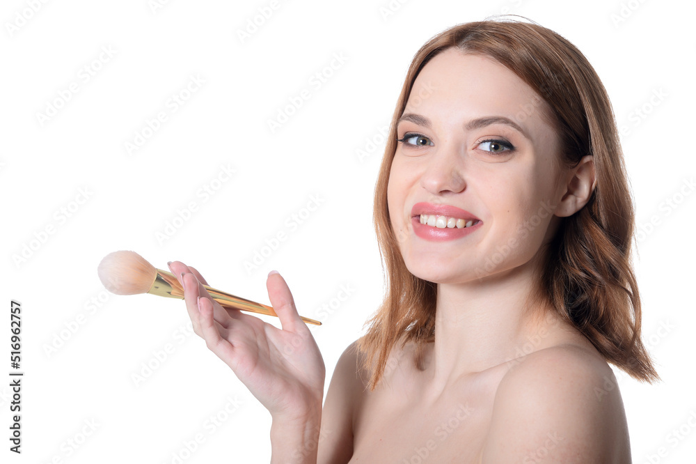 portrait of beautiful young woman posing with make up brush portrait of beautiful young woman posing with make up brush