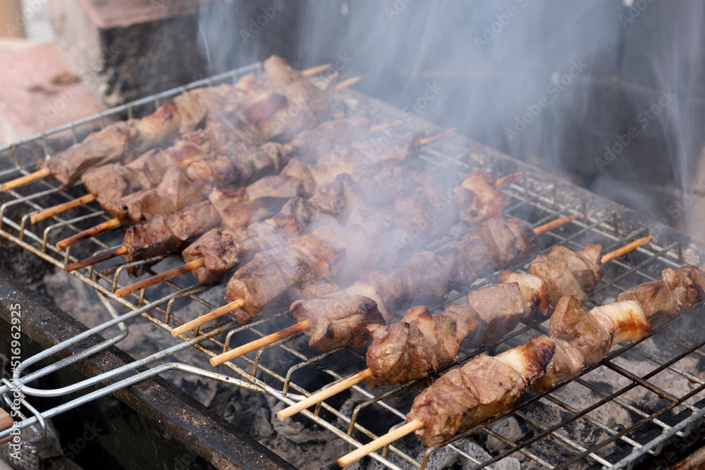Liver kebab, traditional Turkish liver shish or kebap on the grill. Turkish cuisine food culture. Side view of delicious food cooked on the barbecue. Not vegetarian, lamb liver, barbecue smoke. Liver kebab, traditional Turkish liver shish or kebap on the grill. Turkish cuisine food culture. Side view of delicious food cooked on the barbecue. Not vegetarian, lamb liver, barbecue smoke.