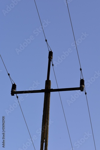 Power linea and an electric pole in a blues sky