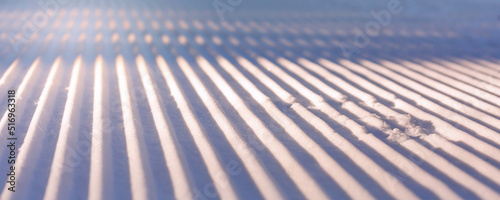 Fresh snow groomer tracks on a ski piste, banner