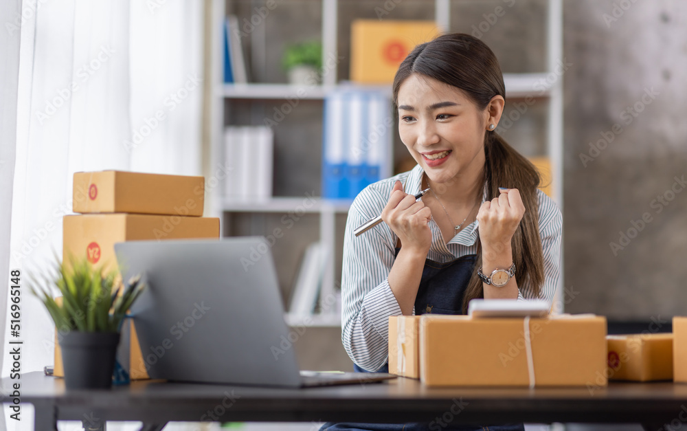 Portrait of young Asian woman working SME with a box at home the workplace.start-up small business owner, small business entrepreneur SME or freelance business online and delivery concept. Portrait of young Asian woman working SME with a box at home the workplace.start-up small business owner, small business entrepreneur SME or freelance business online and delivery concept.