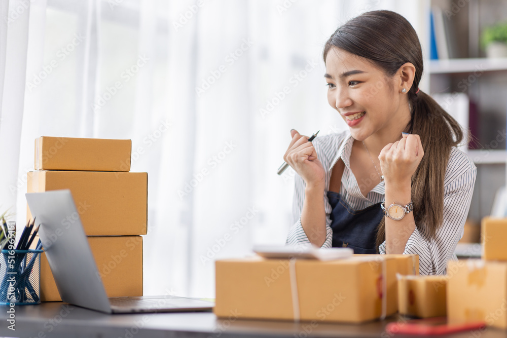 Portrait of young Asian woman working SME with a box at home the workplace.start-up small business owner, small business entrepreneur SME or freelance business online and delivery concept. Portrait of young Asian woman working SME with a box at home the workplace.start-up small business owner, small business entrepreneur SME or freelance business online and delivery concept.