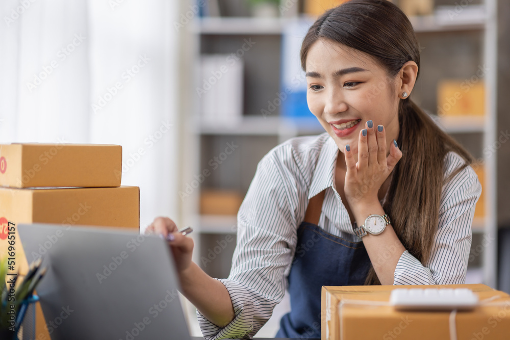 Portrait of young Asian woman working SME with a box at home the workplace.start-up small business owner, small business entrepreneur SME or freelance business online and delivery concept. Portrait of young Asian woman working SME with a box at home the workplace.start-up small business owner, small business entrepreneur SME or freelance business online and delivery concept.