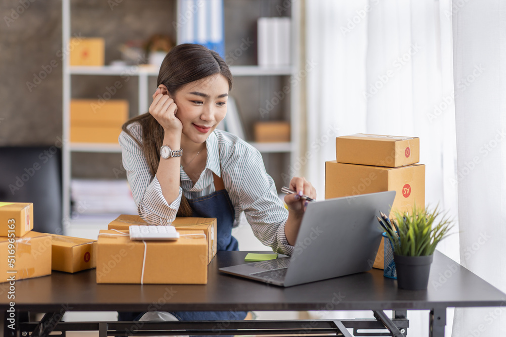 Portrait of young Asian woman working SME with a box at home the workplace.start-up small business owner, small business entrepreneur SME or freelance business online and delivery concept. Portrait of young Asian woman working SME with a box at home the workplace.start-up small business owner, small business entrepreneur SME or freelance business online and delivery concept.
