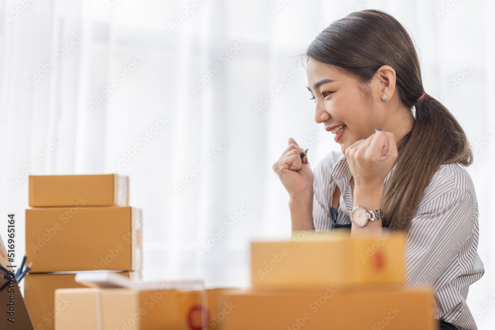 Portrait of young Asian woman working SME with a box at home the workplace.start-up small business owner, small business entrepreneur SME or freelance business online and delivery concept. Portrait of young Asian woman working SME with a box at home the workplace.start-up small business owner, small business entrepreneur SME or freelance business online and delivery concept.