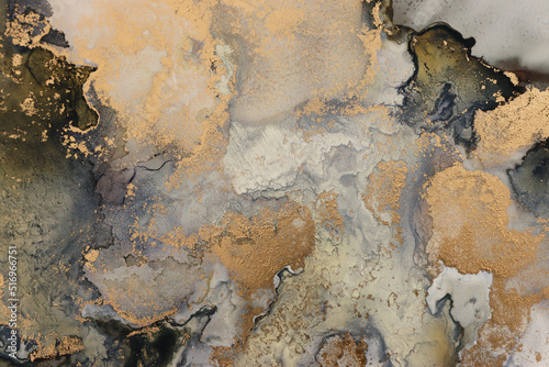 art photography of abstract fluid art painting with alcohol ink, black and gold colors photo