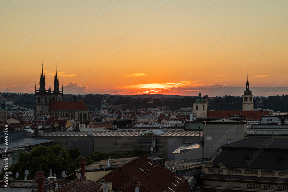 the city of Prague seen from the top of a belfry at sunset
