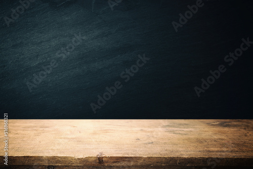 Background of wooden table and black textured stone.