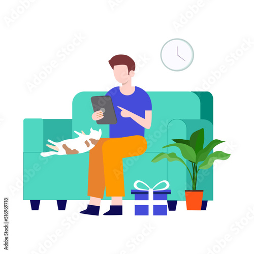 man sitting on sofa with iPad and little cat sleeping on knees.