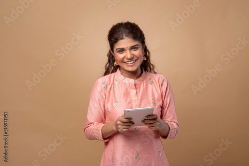 Young happy Indian woman with notebook