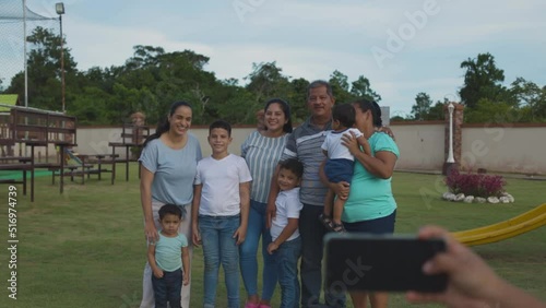 Latino family taking photo in the park, happy