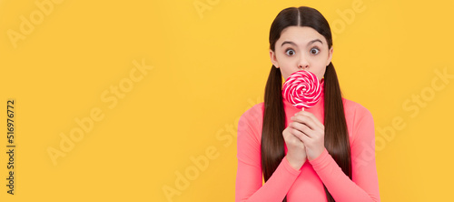 oh my god. teen dental care. sweet tooth. yummy. surprised girl hold lollipop. Teenager child with sweets, poster banner header, copy space. photo