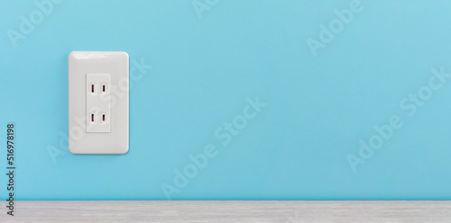 Obraz na płótnie white electric outlet mounted on light blue wall