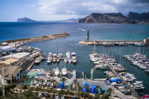 view from above of a small port in the Mediterranean Sea and hotels with mountains in the background Calpe city