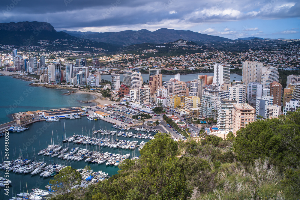 view from above of a small port in the Mediterranean Sea and hotels with mountains in the background Calpe city