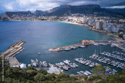 view from above of a small port in the Mediterranean Sea and hotels with mountains in the background Calpe city