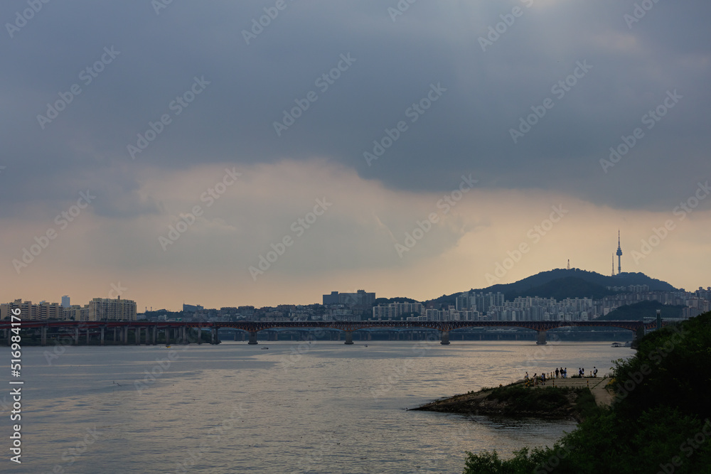 view of the han river, the namsan tower and the bridge at sunset