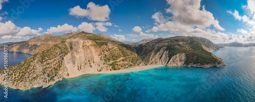 aerial shot drone of myrtos beach, kefalonia island with emerald sea and some clouds with blue sky, horizontal panoramic photo photo