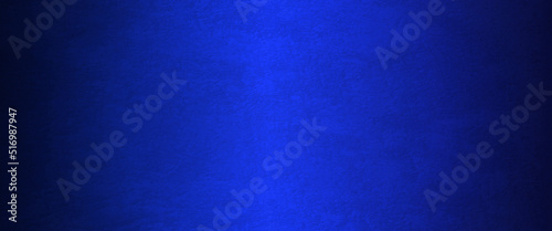 Blue abstract lava stone texture background, dark blue rough grainy stone or concrete wall texture background, Blue background with faint texture and bright center and black vignette border.