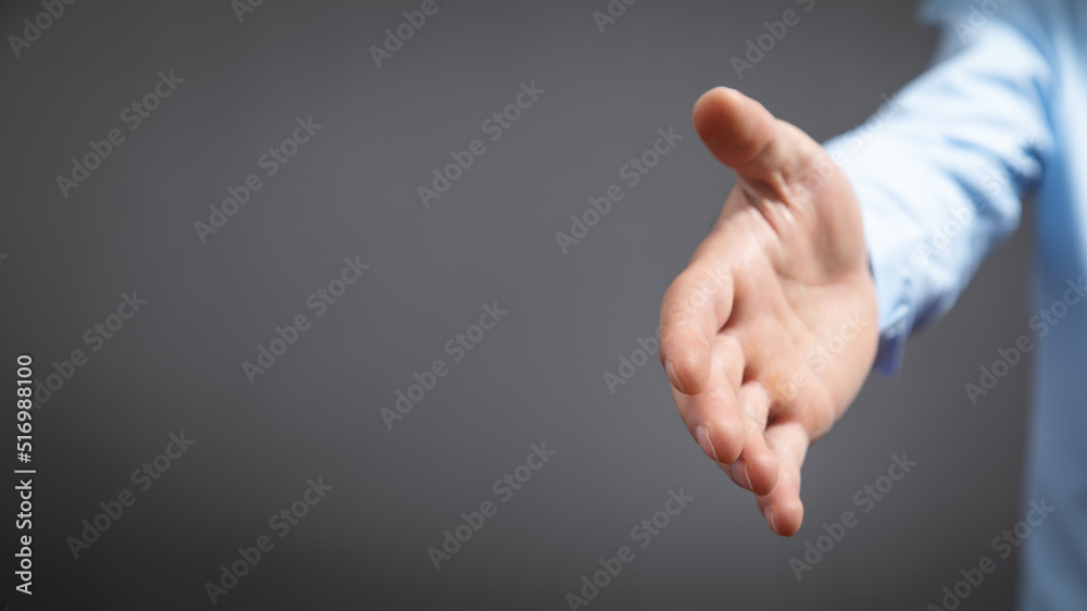Businessman offering hand for handshake at office. Businessman offering hand for handshake at office.