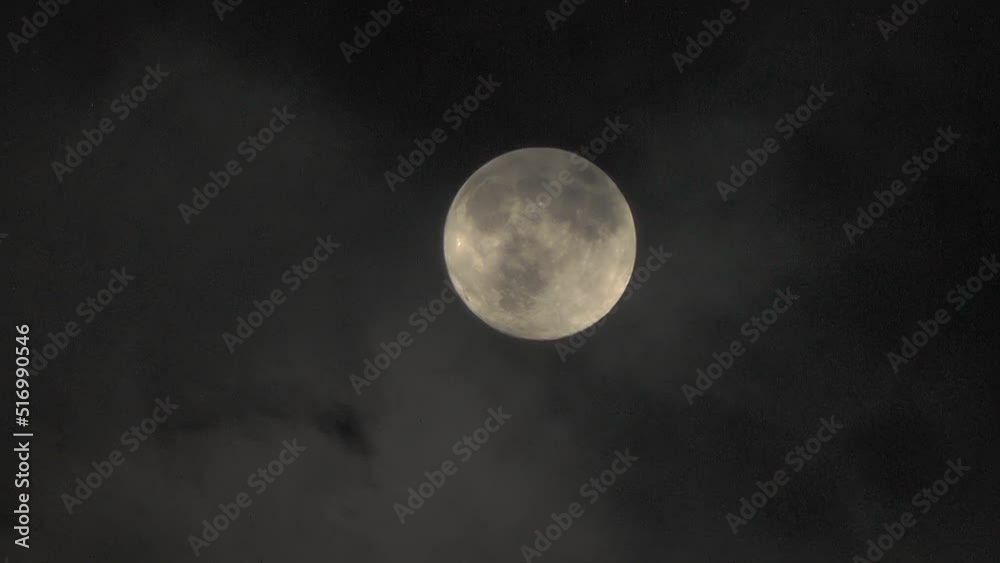 Moon in the clouds. Mystery of the night sky. Clouds are flying fast in front of the Moon. Telephoto zoom Moon in the clouds. Mystery of the night sky. Clouds are flying fast in front of the Moon. Telephoto zoom